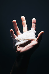 Image showing Bandage, black and hand palm of man with medical injury pain, first aid care and hurt from mma fight, boxing or crime violence. Shadow light, dark trauma wound and sports boxer with injury spotlight