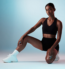 Image showing Fitness, athlete and portrait of young woman in sportswear in a studio background for health. Wellness, active and focus with a fit, strong Indian woman posing in trendy sport clothing on backdrop.