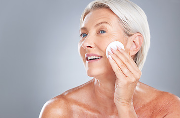 Image showing Cotton pad, skincare and senior woman in studio for beauty, cleaning and grooming on grey background mockup. Face, cotton and elderly model relax with product, cleanser and hygiene, skin and wellness