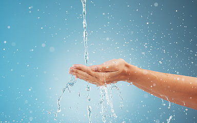 Image showing Abstract water, splash and woman cleaning hands . Clean flow eco friendly healthy, sustainable waterfall environment and earth day fresh cold wet hand under water with blue background in studio