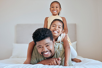 Image showing Family, children and bed with a man, daughter and sister having fun together in their home while bonding. Bedroom, love and playful with a father and daughter siblings laughing or joking in a house