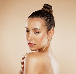 Image showing Face, beauty and skincare with a model woman posing in studio on a beige background for health or body care. Wellness, luxury and cosmetics with an attractive young female posing fo natural treatment