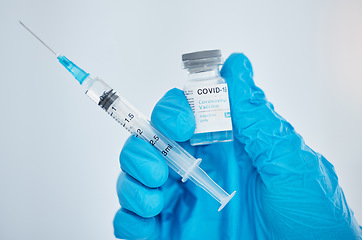 Image showing Doctor, hand and covid vaccine, syringe and medicine for health, safety and protection from virus against mockup space background. Medical expert, glove and covid 19 treatment for pandemic healthcare