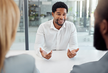 Image showing Black businessman, meeting or job interview in office boardroom with human resources, recruitment or corporate hiring managers. Talking worker, employee or hr candidate with happy smile or motivation