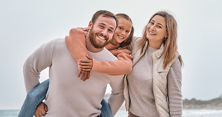 Image showing Happy family, beach vacation and summer travel with child, mom and dad together on adventure by sea with love, support and fun piggy back. Portrait of man, woman and girl outdoor by water for holiday