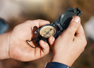 Image showing Hands, compass and travel for direction, map or location in adventure, hike or navigation in the outdoors. Hand of traveler holding tracker for scope, tourism or hiking in exploration for journey