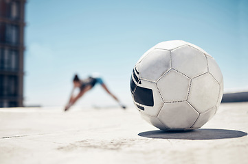 Image showing Soccer ball, sport and fitness, training and exercise, sports workout and athlete stretching, prepare for football outdoor in urban town. Soccer, healthy and active lifestyle, cardio and endurance.