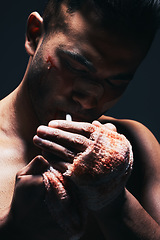 Image showing Fighter, boxer blood and man smoking a cigarette after a exercise fight, match and training. Smoke of a hurt fighting athlete with a bleeding hand injury and workout medical accident from boxing