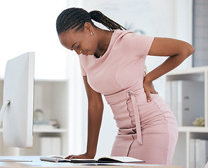 Image showing Back pain, bad posture and strain with a black woman in business suffering while working at her desk in the office. Anatomy, spine and cramp with a female employee struggling with backache at work