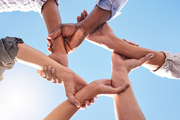 Image showing Hands, community and link team together global community of cooperation on blue sky. Group diversity in volunteer partnership, social solidarity or collaboration friends of circle arms and teamwork