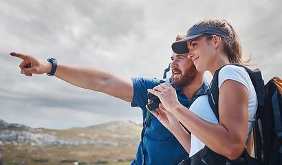 Image showing Pointing, travel and couple hiking on the mountains in a natural environment for an outdoors adventure in Canada. Freedom, lifestyle and healthy woman loves walking or trekking with partner in nature