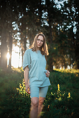 Image showing woman walking early in summer forest area