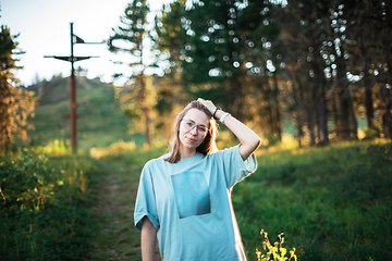 Image showing woman walking early in summer forest area