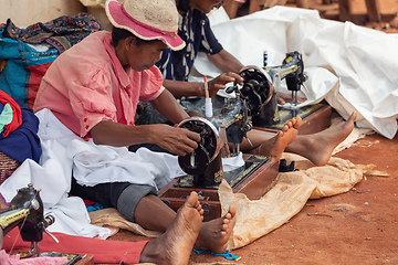 Image showing Street tailors work with their outdated manual sewing machines. Earn some money in Madagascar is very difficult