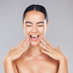 Image showing Woman, smile and hands in beauty for skincare, cosmetics or makeup treatment against a grey studio background. Excited happy female smiling with teeth in satisfaction for perfect luxury cosmetic care