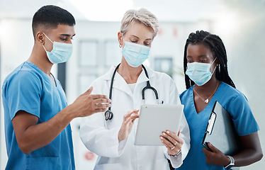 Image showing Digital tablet, face mask and team of doctors in collaboration doing covid research with technology. Teamwork, pandemic and healthcare workers consulting on medicine with a mobile device in hospital.