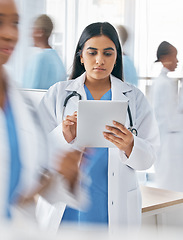 Image showing Doctor, tablet and busy hospital with internet research, online schedule and digital calendar at work. Medical worker working in healthcare clinic planning with digital tech to check patient records