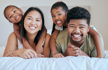 Image showing Happy family, bed and girl with mother, father and sister in a bedroom for fun, bond and rest together. Face, portrait and mexican family hug, smile and happy with kids and parents embrace in Mexico