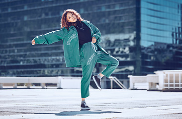 Image showing City, dance and dancing woman on a rooftop with cool hip hop street fashion and creative artistic freedom. Balance, moving and young girl dancer in training, cardio workout and body exercise outdoors