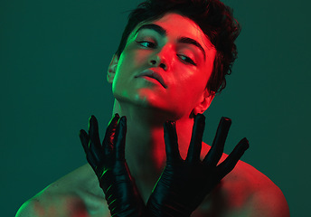 Image showing Art, neon lights and creative portrait of man with leather gloves, serious face and self expression. Futuristic cyberpunk fashion, topless male model and artistic beauty on green studio background.