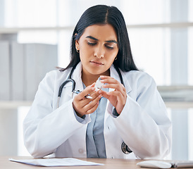 Image showing Woman with medication prescription, health and doctor in hospital office, focus and reading instruction label. Healthcare, stethoscope and medical paperwork on desk, vaccine or cold and flu medicine.