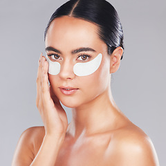 Image showing Eye patches, skincare and face of woman isolated on a gray studio background. Beauty, portrait and female model from Australia with cosmetics product or collagen eye mask for health or skin hydration