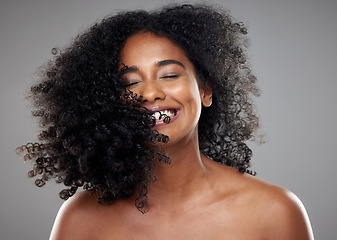 Image showing Black woman, hair and beauty, hair care or curly hair on gray studio background. Smile, skincare and young beautiful female model from Nigeria with healthy curls after luxury salon treatment.