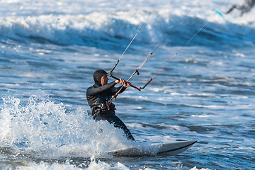 Image showing Kitesurfer riding ocean waves