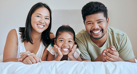 Image showing Family, children and bed with a mother, father and daughter lying in a bedroom of their home together. Relax, love and portrait with a man, woman and girl bonding in the house on a weekend morning