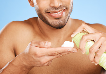 Image showing Hand, shaving cream and man in studio for skincare, beauty and hair care against a blue background with mockup. Hands, foam and face hair grooming with model cleaning, hygiene and skin care product