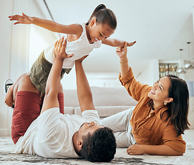 Image showing Love, floor and fun happy family play, bond and enjoy quality time together while excited and relax on ground carpet. Happiness, care and childhood relationship of mom, dad and kid girl playing games