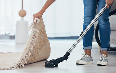 Image showing Vacuum, floor and woman cleaning under a carpet in the living room of a house. Housekeeping, service and cleaner vacuuming in the lounge with a rug or mat for care and disinfection of dirt in home