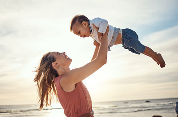 Image showing Family, beach and sunset vacation with mother and lifting child in air for fun, love and care with support. Woman and baby happy about bonding experience while on holiday in Bali for summer travel