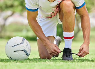 Image showing Sports, soccer and man tie shoe on field, ready for game, match and outdoor training. Fitness, exercise and soccer player tying shoelace on sneaker before workout on soccer field for good performance