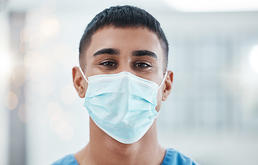 Image showing Covid, healthcare and medicine with a man nurse using a mask in a hospital for health or safety. Portrait, medical and facemask with a male medicare or nursing professional standing alone in a clinic