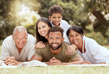 Image showing Black family, happy lying portrait on lawn blanket and summer sunshine in garden together on grass. Mom dad, child grandparents and outdoor happiness, relax on holiday vacation and love bonding time