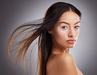 Image showing Beauty, face and vitiligo with a model woman in studio on a gray background to promote skincare. Wellness, luxury and portrait with an attractive young woman posing for a natural cosmetic product