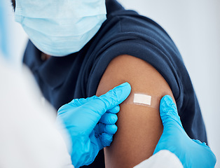 Image showing Covid vaccine, plaster and doctor with patient for healthcare consultation, hospital first aid or covid 19 medical service. Corona virus, band aid and prevention vaccination for black man at clinc