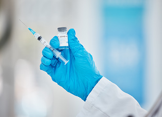 Image showing Doctor hands, covid or vaccine bottle with syringe in hospital, clinic or pharmacy for health, wellness or medical compliance. Zoom, nurse or healthcare worker and covid 19 booster medicine or needle