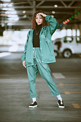 Image showing Urban, fashion and girl portrait at parking lot in New York with edgy athleisure style. Gen Z, trendy and statement clothes of young city woman with assertive, confident and cool pose.