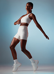 Image showing Fitness, dancing and body of black woman balance in studio mock up for energy, workout training or wellness marketing portrait. Sports, athlete and dancer model exercise clothes, sneakers or fashion