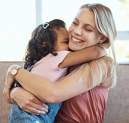 Image showing Mother, hug and child love on a home living room sofa feeling interracial family and kid care. Mama, happy girl and parent loving her kid with a smile on a house lounge couch hugging in a family home