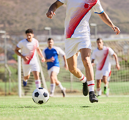 Image showing Soccer, team and running in sports game, fitness or exercise with the ball on the field in the outdoors. Group of football players on the attack for goal, score or match point on the soccer field