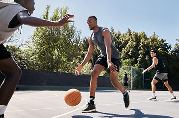 Image showing Fitness, basketball and athlete on an outdoor court playing a match or training as a team. Motivation, exercise and healthy basketball player practicing with a ball for a sports game in South Africa.