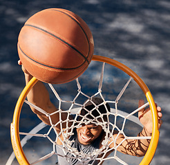 Image showing Basketball sports, black man and top view of dunk at basketball court, training game or match. Fitness, energy jump and basketball player scoring point or practice goal, exercise or workout outdoors.