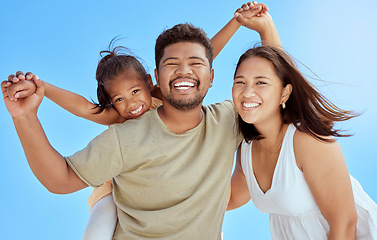 Image showing Blue sky, hug and portrait of fun happy family play, bond or enjoy outdoor quality time together. Love, summer freedom and excited father, mother or parents with kid girl on Malaysia holiday vacation