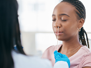 Image showing Woman, doctor and covid test in a hospital for healthcare, research and innovation. Black woman, nose and corona swab with nurse in consultation room for compliance, results and health checkup