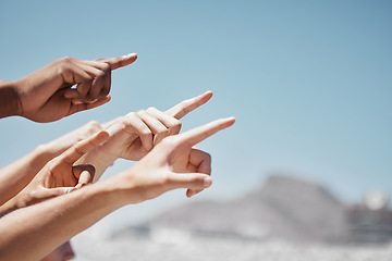 Image showing Group hands, fingers and pointing to sky mockup, direction and advertising space of global community outdoors. Closeup diversity people showing body language sign to blue sky, hope and ideas