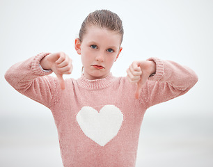 Image showing Thumbs down, sad kid and girl portrait show wrong sign, poor review and no body language to problem, failure and bad opinion. Disappointed young child hands refuse, rejection and hate, dislike and no