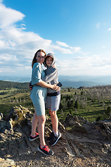 Image showing A child embraces mom in the mountain trip